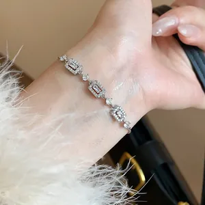 Close-up of elegant silver-colored bracelet with sparkling rectangular zircon accents.