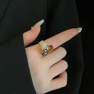 Detailed view of a gold plated geometric open ring with sparkling cubic zirconia crystals