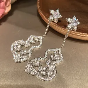 Detail view of New Chinese style silver gourd tassel earrings encrusted with zircon flowers