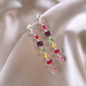 Close-up of elegant long tassel earrings with vibrant multi-color zircon stones.