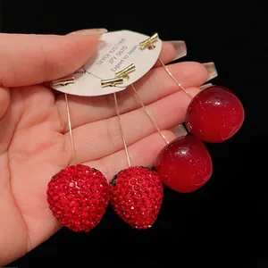 Sweet red rhinestone strawberry and cherry dangle earrings with gold-tone hardware.