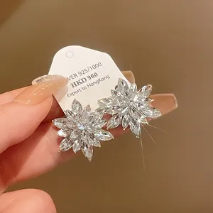 Close-up view of elegant sparkling crystal flower stud earrings with silver needles