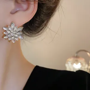 Elegant close-up shot of a sparkling rhinestone flower stud earring with silver needle detail