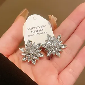 Detailed view of the sparkling crystal petals on these silver-tone flower stud earrings