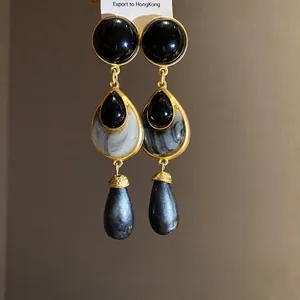Elegant vintage gold-plated drop earrings with black marble and pearlized texture