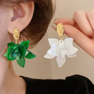 Elegant handcrafted resin flower earrings with silver needles in green and white colors.