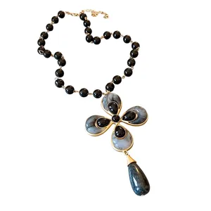Elegant vintage flower pendant necklace with black beads and grey marble effect stone