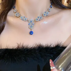 Close-up view of elegant French vintage floral necklace set with sparkling blue crystals