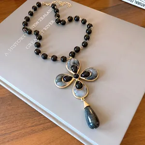 Detailed close-up of a vintage flower pendant necklace with elegant marbled resin