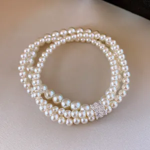 Detailed macro shot of an elegant multi-layer pearl bracelet with zircon clasp