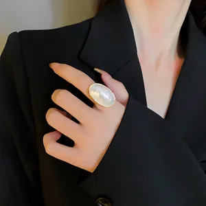 Elegant oversized oval mother-of-pearl ring with minimalist gold-plated band for women
