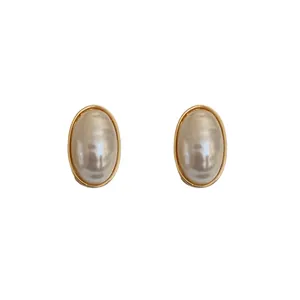Elegant oval pearl stud earrings with minimalist gold-plated borders for women's fashion.