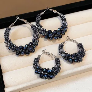 Elegant vintage-style hoop earrings featuring dark blue faceted glass beads on silver hoops.