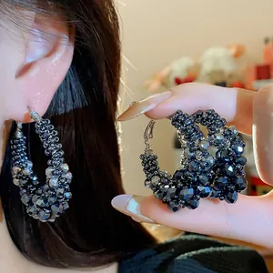 Detailed macro view of vintage black faceted glass bead hoop earrings for women