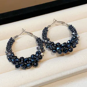 Close-up detail of vintage-style hoop earrings featuring faceted black glass beads