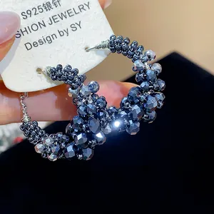 Close-up of vintage irregular black glass beaded hoop earrings with S925 silver needles.