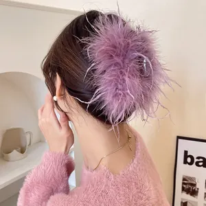 Detail view of an elegant purple feather hair claw clip for fairy-style bun hairstyles