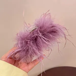 Detailed view of the fluffy purple feather hair claw clip for elegant hair styling