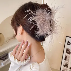 Side view detail of an elegant feather hair claw clip for a refined bun hairstyle