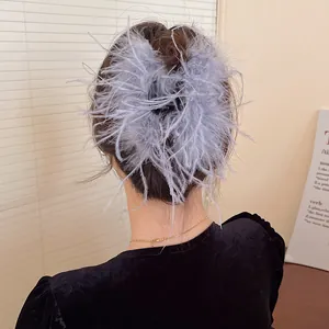 Detailed view of an elegant blue feather hair claw clip for a fairy hairstyle look