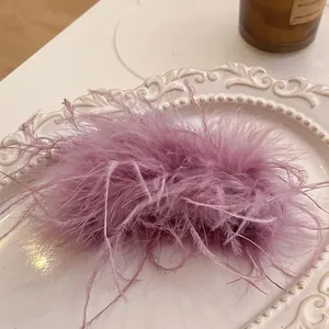 Macro view of elegant purple feather hair claw clip on vintage tray