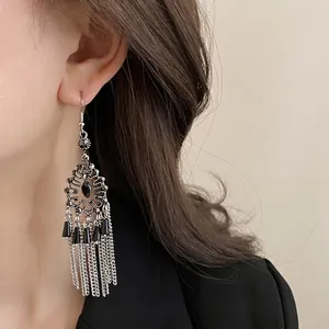 Vintage silver-tone chandelier earrings with black stones and long chain tassels.