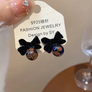 Dettaglio orecchini fiocco nero floccato con perline leopardate su perni in argento S925