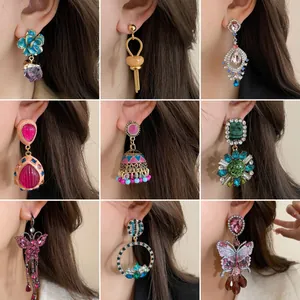 Assorted vintage palace style rhinestone earrings featuring floral and butterfly designs