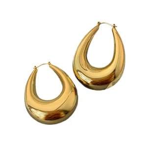 Minimalist chunky gold teardrop hoop earrings with high-polish metallic finish.