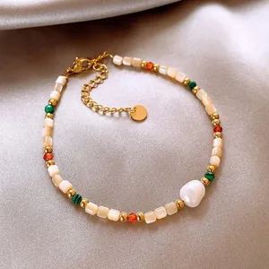 Detail view of 18K gold plated bracelet with shell beads and baroque pearl