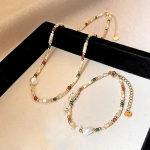 Detail of shell bead and pearl jewelry set with 18K gold plating and colorful beads.