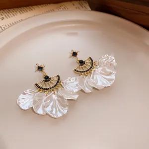 Vintage gold-toned fan earrings with elegant black rhinestones and white resin petals.