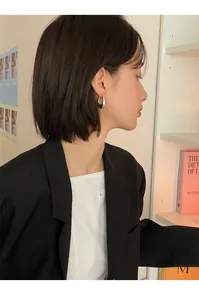 Detailed side view of an Asian model wearing minimalist silver oval waterdrop hoop earrings