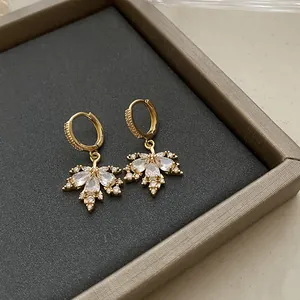 Detailed close-up of vintage gold hoop earrings with marquise cubic zirconia flowers.