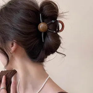 Pince à cheveux géométrique marron style français rétro dans un chignon élégant