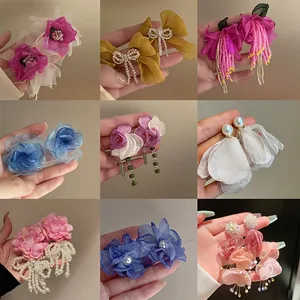 Multi-style collection of dopamine mesh flower and pearl drop earrings for women.