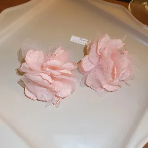Macro detail showing the delicate layered pink mesh of these floral stud earrings.