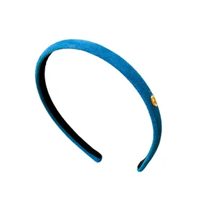Elegant blue flocked fabric headband with gold Love charm for modern women's hair styling