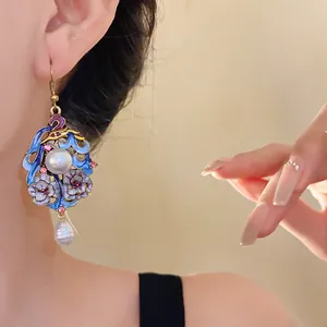 Close-up view of vintage ethnic style drip oil earrings with flowers and pearl drops