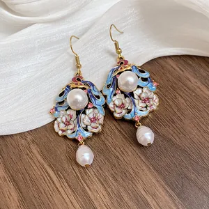 Detailed macro view of vintage enamel flower earrings with elegant white pearl drops.