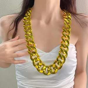 Close-up detail of a chunky gold acrylic chain necklace in a trendy punk rock style