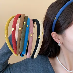Detailed macro view of colorful flocked headbands with elegant small gold 'Love' metal tags