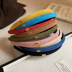 Macro view of assorted colorful velvet thin headbands with elegant gold Love accents