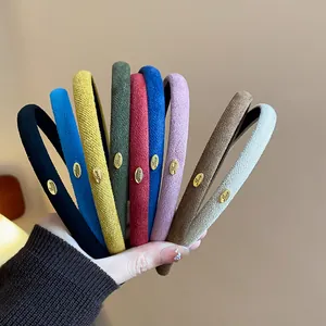 Detailed close-up showing texture of colorful flocked fabric headbands with gold 'Love' tags.