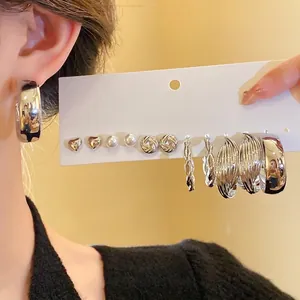 Elegant silver mixed earring set featuring hearts, hoops and pearls on a display card.