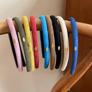Detailed view of colorful flocking fabric headbands hanging on a wooden chair