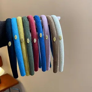 Collection of colorful flocked thin headbands featuring elegant gold Love metal charms