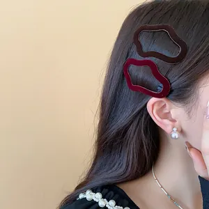 Detail shot showing flocking irregular geometric hair clips worn by a female model