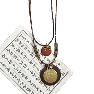 Handcrafted ethnic style wood bead necklace with a retro Zen spiral pendant design
