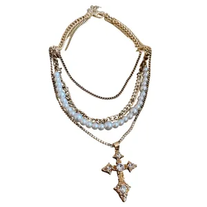 Vintage gold layered necklace with white pearls and ornate crystal cross pendant